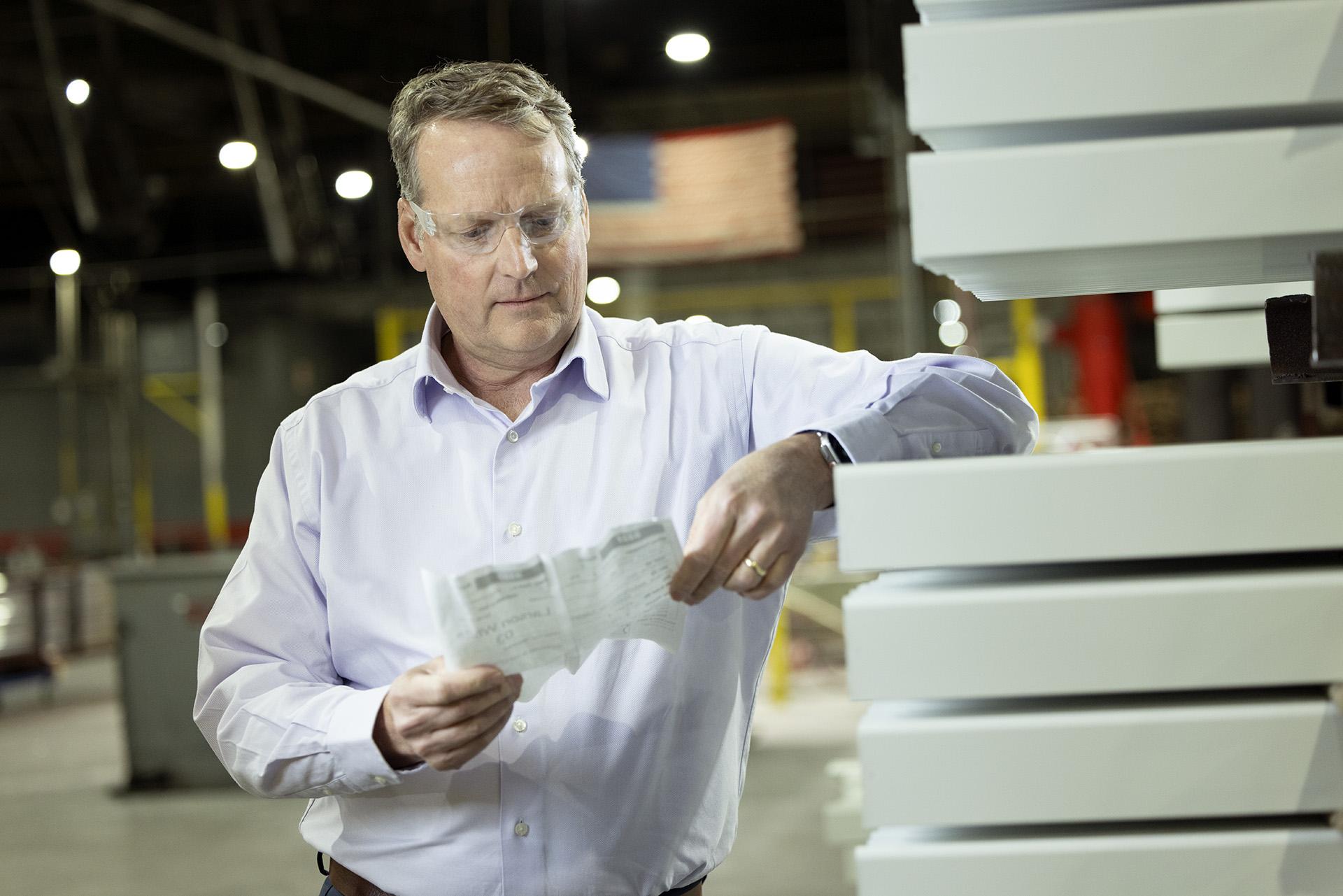 brook examining the production line 